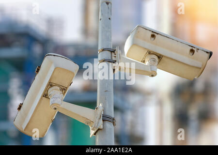 CCTV camera concept with refinery on blurry background Stock Photo