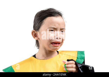 Asian little girl in a graduation gown holding certificate crying isolated over white background Stock Photo