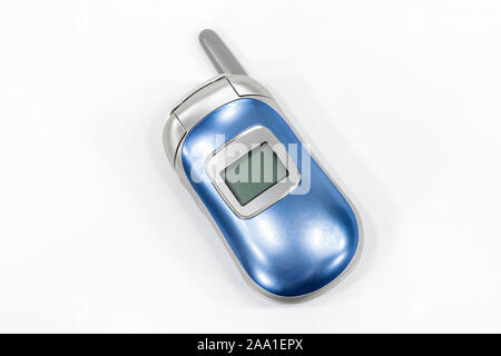 Cute little flip style cell phone with white background. Stock Photo
