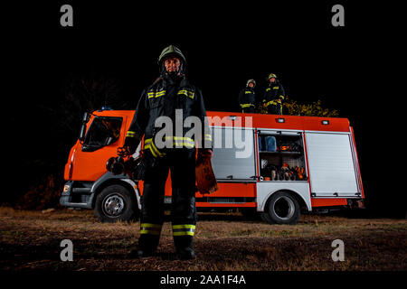 Fire brigade during operation in the field at night time Stock Photo