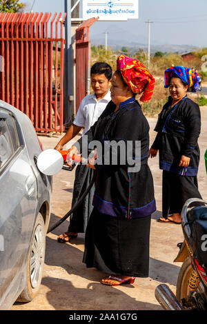 A Woman From The Pa’O Ethnic Group Puts Petrol (Gas) In To A Car, Taunggyi, Shan State, Myanmar. Stock Photo