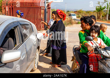 A Woman From The Pa’O Ethnic Group Puts Petrol (Gas) In To A Car, Taunggyi, Shan State, Myanmar. Stock Photo