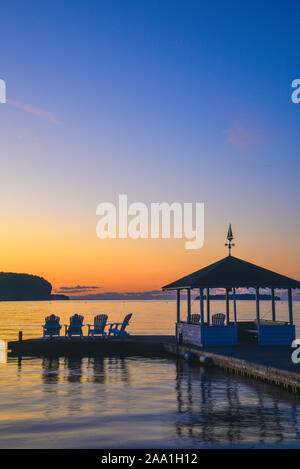 Spectacular golden sunset over the calm waters of Green Bay and Peninsula State Park, sitting on Adirondack chairs, gazebo, Ephriam, Wisconsin, USA Stock Photo