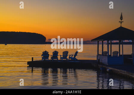 Spectacular golden sunset over the calm waters of Green Bay and Peninsula State Park, sitting on Adirondack chairs, gazebo, Ephriam, Wisconsin, USA Stock Photo