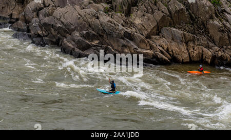 Two men on Kayaks paddlying on the river at Great Falls National Park, Virginia Stock Photo