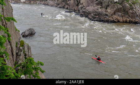 Two men on Kayaks paddlying on the river at Great Falls National Park, Virginia Stock Photo