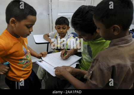 Kuala Lumpur, Selangor, Malaysia. 11th Nov, 2019. Some kids helping the older student in class at the academy.Rohingya English Academy is a learning centre that offers free education to the Rohingya refugees both children and adults, it was founded by Saif Ullah a Rohingya citizen living in Malaysia and also an English tutor at the academy who receives no support from the government. Malaysia has more than 177,690 registered refugees and asylum seekers from Rohingya according to UNHCR statistic and 45,470 of them are children under the age of 18. (Credit Image: © Faris Hadziq/SOPA Images v Stock Photo