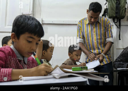 Kuala Lumpur, Selangor, Malaysia. 11th Nov, 2019. Saif Ullah with his little students in class at the academy.Rohingya English Academy is a learning centre that offers free education to the Rohingya refugees both children and adults, it was founded by Saif Ullah a Rohingya citizen living in Malaysia and also an English tutor at the academy who receives no support from the government. Malaysia has more than 177,690 registered refugees and asylum seekers from Rohingya according to UNHCR statistic and 45,470 of them are children under the age of 18. (Credit Image: © Faris Hadziq/SOPA Images v Stock Photo