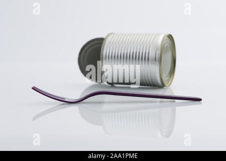 Close up, single use, disposable, fork, tin can, food container on high key background, plastic pollution, consumerism Stock Photo