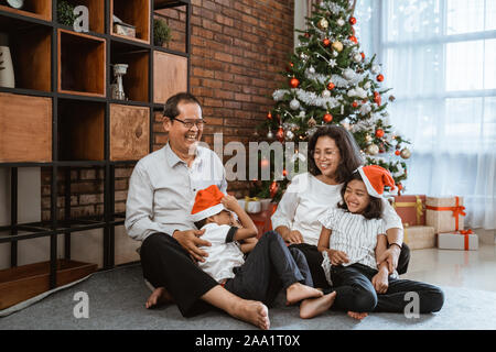 grandparents and child playing together on christmas day Stock Photo