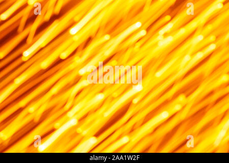 Futuristic blurred lights holiday monochrome background in yellow. Horizontal, soft focus Stock Photo