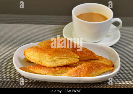 Sugar puff pastry or sugar khari with a cup of tea Stock Photo