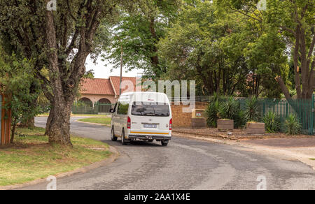 Alberton, South Africa - a privately operated minibus taxi travels on a street in a residential suburb image in horizontal format Stock Photo