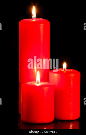 Three red candles on black background Stock Photo
