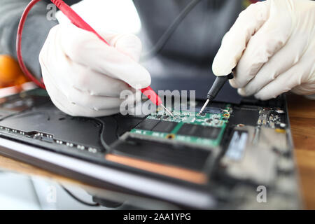 Technician soldering laptop parts Stock Photo