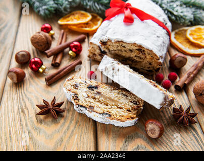 Christmas stollen on wooden background. Traditional Christmas festive pastry dessert. Stollen for Christmas. Stock Photo