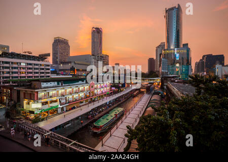 Skyscraper and Pratunam pier in Bangkok; water transportation by speed boat is one of the alternative choice for solving the traffic congestion proble Stock Photo