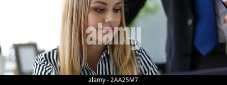 Beautiful clerk in office talking with male colleague Stock Photo