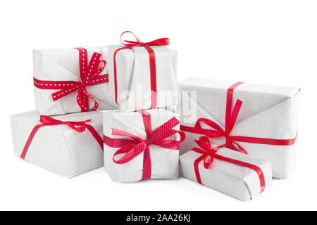 Heap of similar Christmas silver gift boxes with red ribbon decor isolated on white background Stock Photo