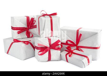 Heap of similar Christmas silver gift boxes with red ribbon decor isolated on white background Stock Photo