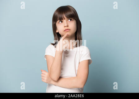 Close up portrait with planning little brown-haired girl. Stock Photo