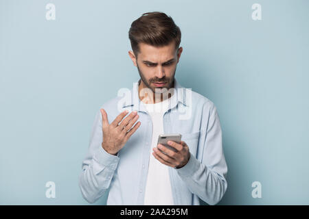 Close up portrait with handsome young man with mobile phone. Stock Photo