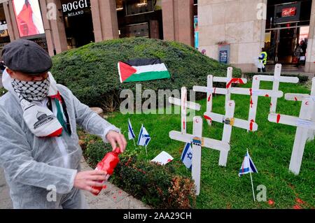 Flash mob by the street artist Cristina Donati Meyer with the youth of the Palestinian association of Italy in Piazza San Babila where white crosses are planted against the massacre of children in Gaza Editorial Usage Only Stock Photo