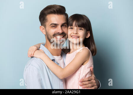 Close up portrait with happy parent and little brown-haired girl. Stock Photo