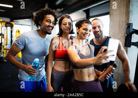Group of sportive people in a gym taking selfie. Concepts about lifestyle and sport in fitness club Stock Photo