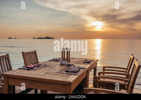 Outdoor cafe on the beach during sunset on Koh Chang island, Thailand. Stock Photo