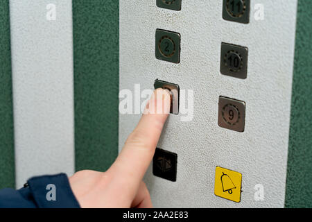 Pressing the button in the elevator Stock Photo