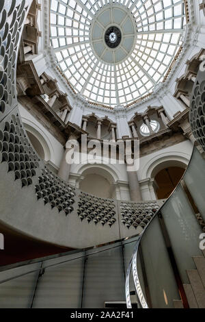 The glass domed atrium and elegant spiral staircase at Tate Britain, Millbank, London, UK Stock Photo