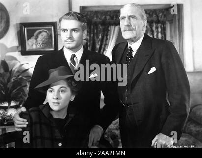 JOAN FONTAINE as the second Mrs. de Winter LAURENCE OLIVIER as Maxim de Winter and C. AUBREY SMITH as Colonel Julyan in REBECCA 1940 director ALFRED HITCHCOCK novel DAPHNE DU MAURIER producer DAVID O. SELZNICK  Selznick International Pictures / United Artists Stock Photo