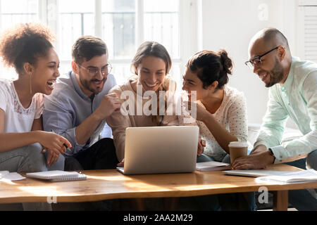 Overjoyed diverse millennial people having fun in dormitory. Stock Photo
