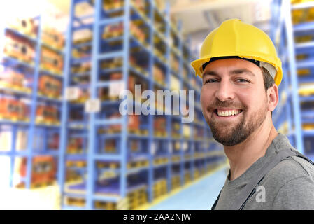 cheerful industrial worker in a factory in work clothes to repair machines and equipment Stock Photo