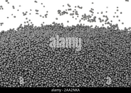pile of dark polystyrene beadlets in white back Stock Photo