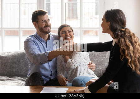 Young spouse shaking hands with professional financial consultant. Stock Photo