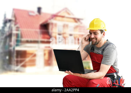 customer service com craftsmen - workers with telephone and notebook on the construction site Stock Photo