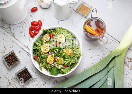Healthy diet.Green lettuce with baked leek, feta cheese and cherry tomatoes. Stock Photo