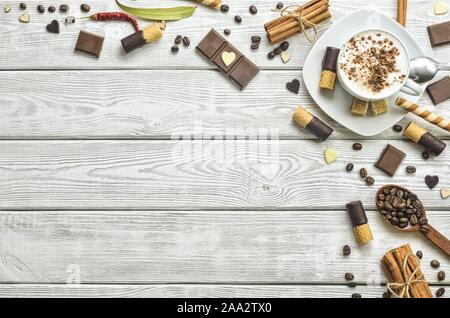 Interesting concept for serving black coffee. Background with coffee with cinnamon and sweet decoration. Stock Photo
