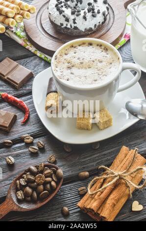 Elegant concept of serving coffee in vintage style. Coffee with foam and cinnamon with various sweets and decoration. Stock Photo