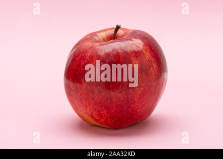 Red apple, on a pink background, Jonagold Stock Photo