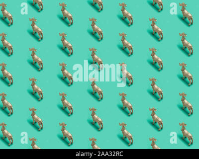 Christmas, trendy pattern, isometric photography, Golden reindeers, green isolated background, winter, autumn,  Minimal Christmas or New Year concept. Stock Photo