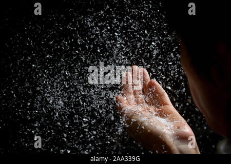 Woman Blowing Fake Snow in The Dark Stock Photo
