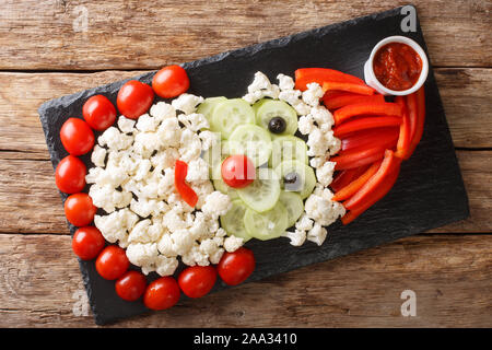 Diet Christmas appetizer in the shape of Santa Claus close-up on the table. Beautiful presentation. horizontal top view from above Stock Photo