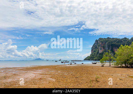 Big low tide on the Railay Beach in a beautiful sunny day with white clouds. Krabi, Thailand Stock Photo