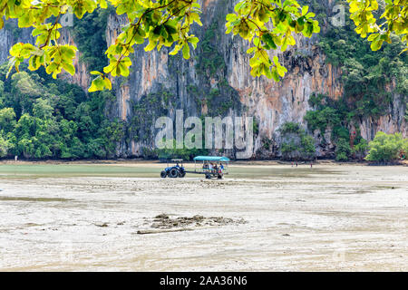 Big low tide on the Railay Beach in a beautiful sunny day with white clouds. Krabi, Thailand Stock Photo