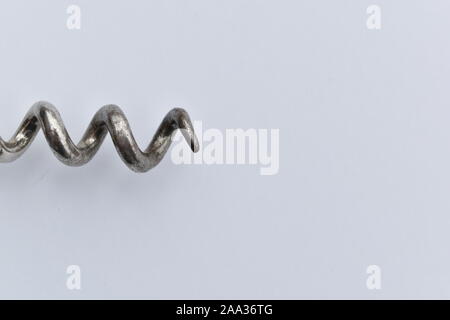 Isolated closeup of silver corkscrew on white background for you to attach your text message or image on. Stock Photo