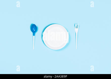 Plastic concept. Bad utensils on blue background. Flat lay, top view, copy space. Stock Photo