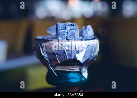 hot coals with hookah sparks in metal bowl for Shisha Smoking and traditional Asian relaxation close up Stock Photo